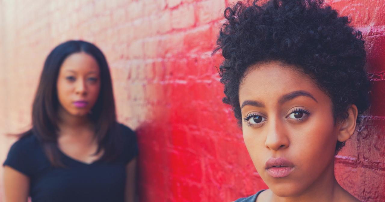Two black women look into the camera