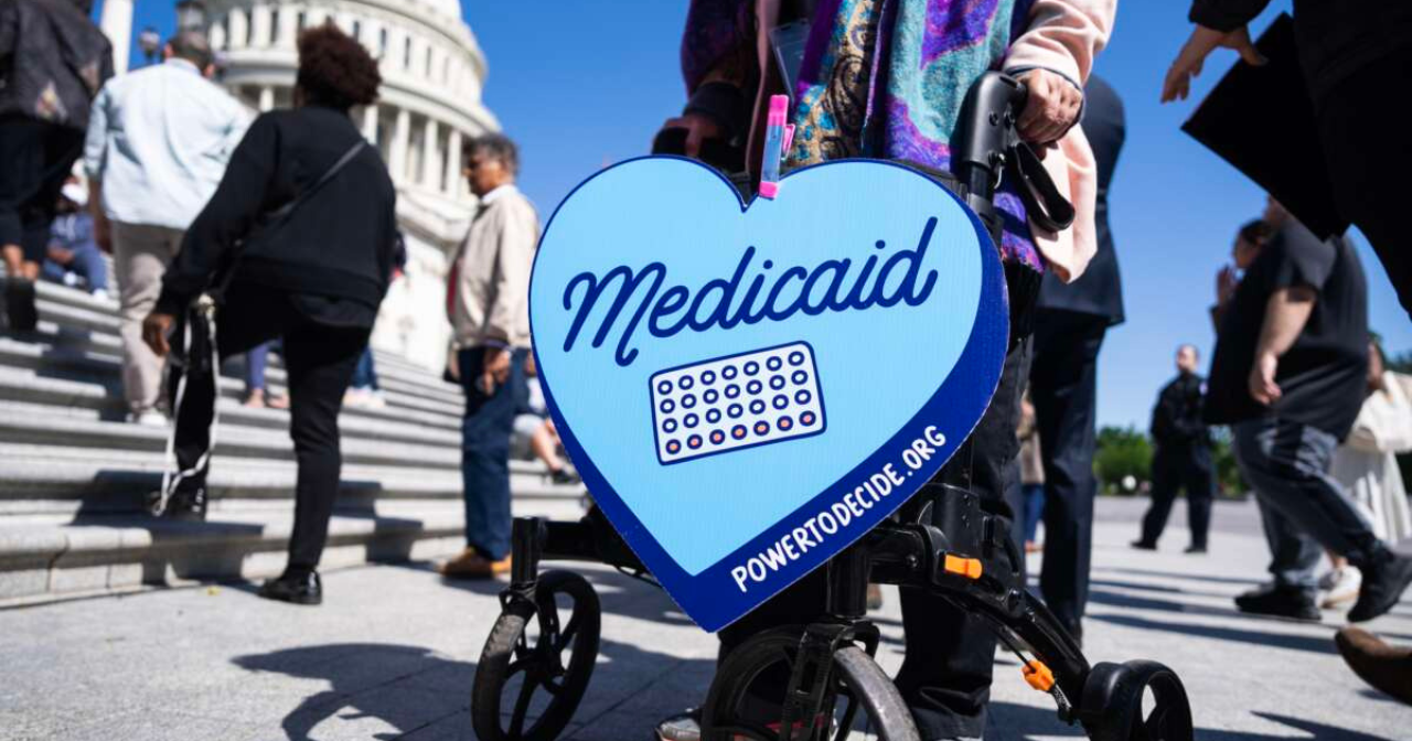 A heart sign supporting Medicaid being held outside the Capitol building. 