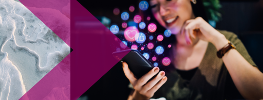 An image of a woman on a phone with social media likes bubbles floating around her head from the screen. 