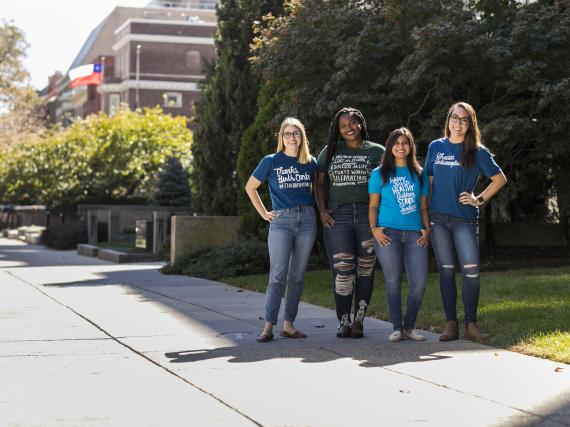 Four people wearing Thanks, Birth Control tshirts