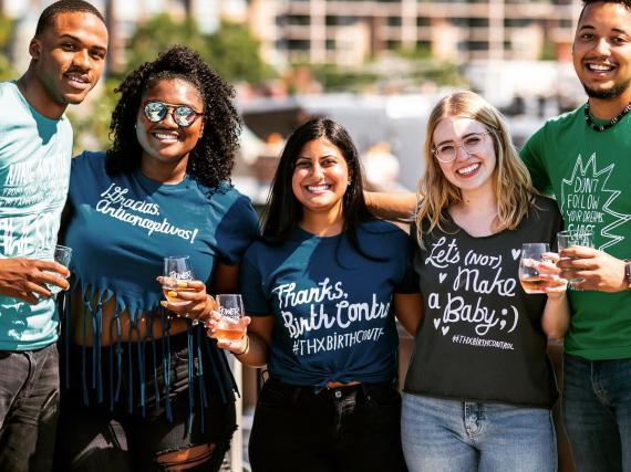 a group of people wearing various #thanksbirthcontrol shirts