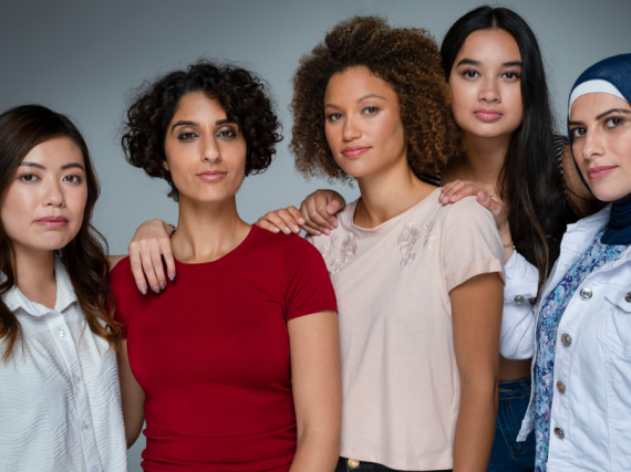A group of diverse women posing for the camera