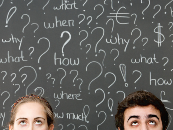 Two faces in front of a chalkboard