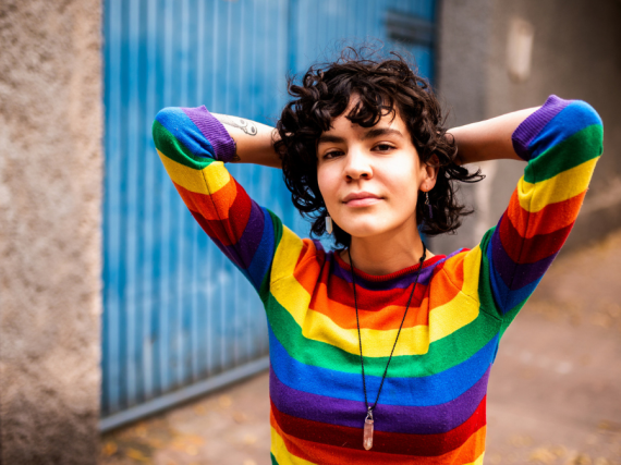 A woman in a rainbow shirt