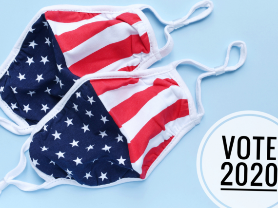 Two face masks with the American flag printed on them and a button that reads, "Vote 2020"