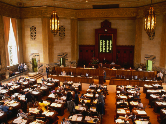 A photo of a state house legislature room not in session. 