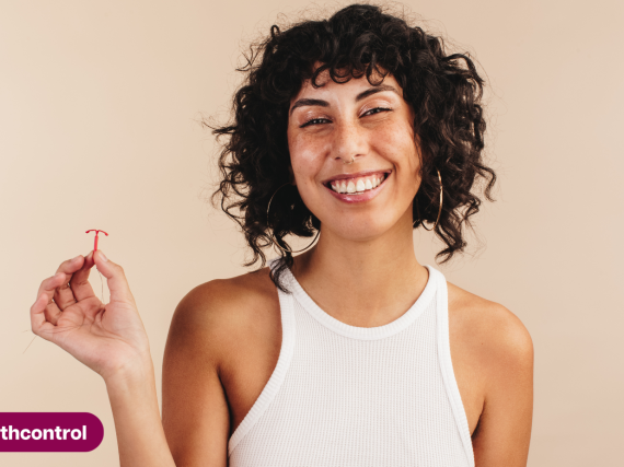 Woman holding an IUD for the 13th Thanks, Birth Control Day