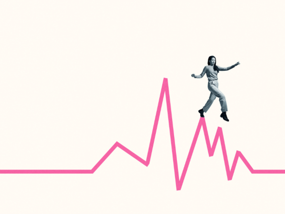 An image of a woman walking along the highs of a line graph. 